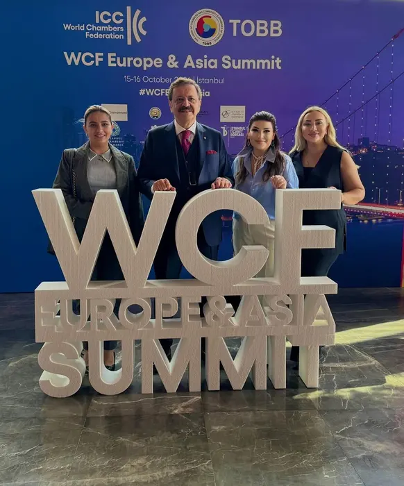 With delegates in front of the WCF Europe & Asia Summit sign